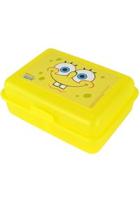 Yellow plastic lunchbox with a lid featuring a smiling cartoon character's face, blue eyes, and a textured surface with light yellow polka dots.
