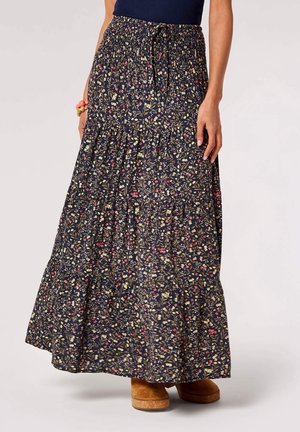 Navy floral maxi skirt with gathered waist, tiered design, featuring small, colorful floral patterns. Soft fabric with flowing texture.