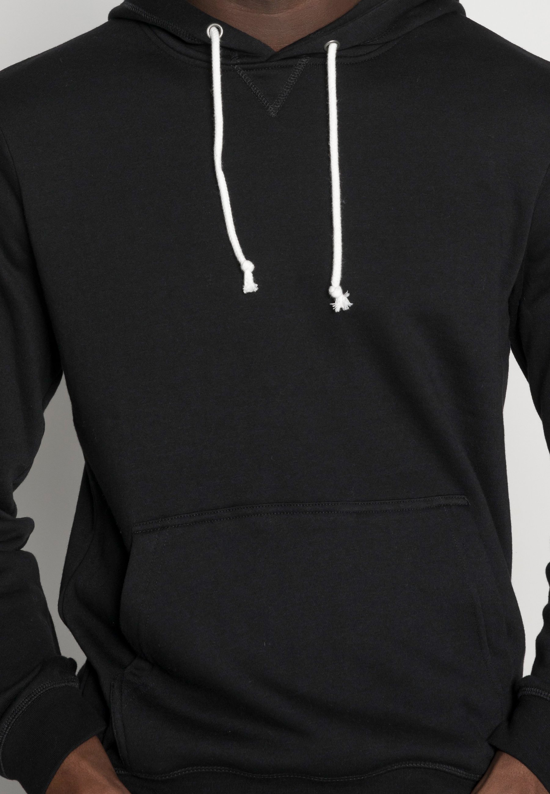 black pullover hoodie with white strings