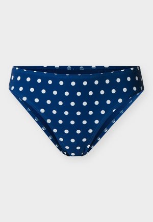 Marineblaue Bikinihosen mit weißen Punkten, mittelhoher Schnitt und glattem Stoff, flach auf einem hellen Hintergrund liegend.