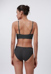 Dark grey ribbed bralette with thin straps and matching high-waisted briefs, featuring a smooth texture and seamless design.
