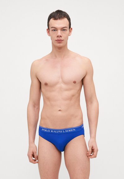 Blaue Baumwollslips mit elastischem Bund, der das weiße Logo "POLO RALPH LAUREN" zeigt, figurbetontes Design, weiche Textur, ohne sichtbare Muster.