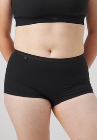 Black cotton shorts with a smooth texture, featuring a soft elastic waistband. Includes a small label on the side.