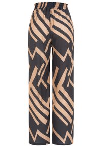 Pantalon à jambes larges avec taille élastique présentant un motif géométrique abstrait audacieux en beige et noir en zigzag.