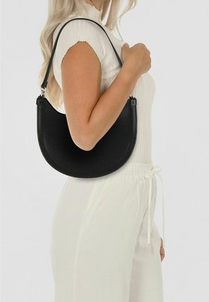 Sac à main noir tissé avec une forme incurvée, doté d'une courte sangle noire et de ferrures argentées pour l'attache. Texture lisse, design compact.