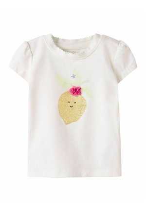 White toddler T-shirt with puff sleeves featuring a glittery lemon graphic with a smiling face and a pink fabric flower on top.