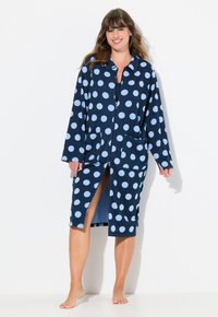 Accappatoio a pois blu navy con cerchi azzurri, maniche lunghe, tasche e zip frontale. Tessuto morbido, design fino al ginocchio.