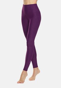 Leggings violet taille haute en matière lisse et extensible, dotés d'une coupe ajustée et d'un logo près de la cheville.