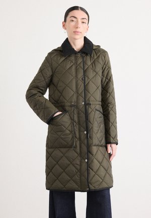 Quilted olive green coat with a black collar, drawstring waist, and two front pockets. Features snap buttons and black trim accents.