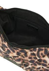 Bolso de estampado de leopardo acolchado con un interior negro. Cuenta con cierre de cremallera y un bolsillo interior para organización. Material texturizado y ligero.