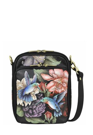 Black faux leather crossbody bag featuring vibrant floral and hummingbird print, gold hardware, and adjustable strap. Compact rectangular shape.