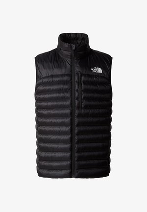 Zwarte poofy vest met hoge kraag, volledige ritssluiting en ritszak op de borst. Heeft een gewatteerd patroon en het logo van The North Face.