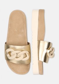 Gold metallic slide sandals with a wide strap featuring a cream chain design, soft beige footbed, and a contrast white serrated sole.