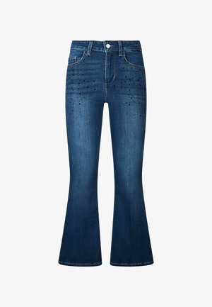 Rozšířené tmavě modré džíny vyrobené z denimu, s dekorativními černými cvočky na předních kapsách a zapínáním na knoflík v pase.