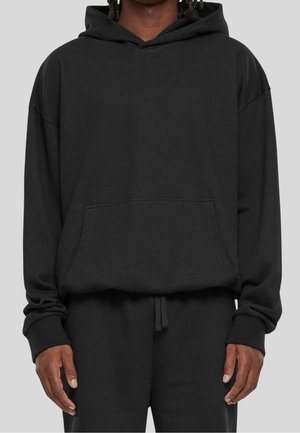 Zwarte oversized hoodie van zachte stof, met een voorzak, een capuchon met trekkoord en geribbelde manchetten, gecombineerd met een bijpassende broek.