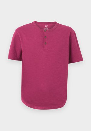 Majica s kratkim rukavima henley u vibrantnoj magenta boji. Ima okrugli izrez, placket s tri gumba i blago zakrivljen rub. Mekana tekstura.