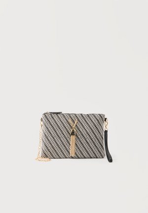 Small black-and-white diagonal striped clutch with gold V-shaped tassel detail, zipper top, and gold chain with black wrist strap.