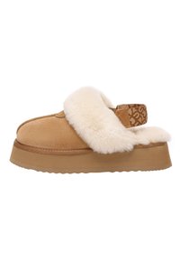 Tan suede slipper with white fur trim, textured strap featuring a logo pattern, and a thick, beige platform sole. Smooth and cozy design.