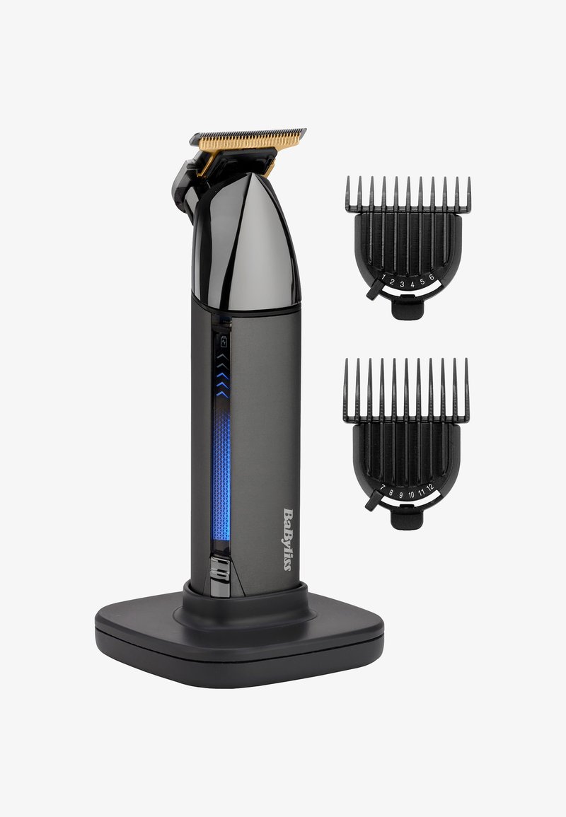 Tondeuse à cheveux noire rechargeable avec lame dorée, indicateur de batterie LED sur le support, et deux guides de coupe noirs réglables numérotés 1-6 et 7-12.