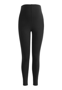 Mustad mustad leggings venivast materjalist, kõrge vöökoht. Sile tekstuur, keha külge sobiv kuju, nähtamatud õmblused või kaunistused.