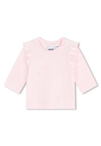 Haut à manches longues rose clair avec des accents volantés, un motif de feuilles subtil et des fermetures à pression à l'épaule. Matière en coton doux.