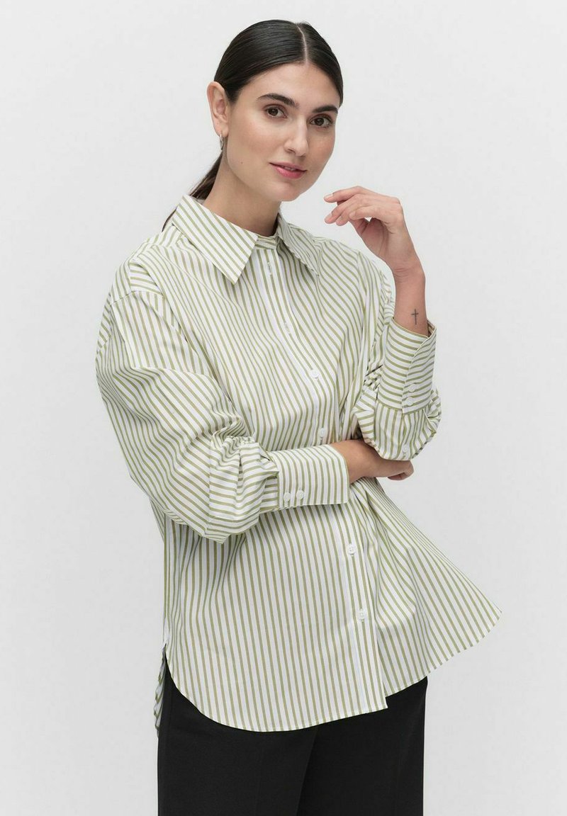 Light green and white striped oversized shirt with a button-up front, long sleeves, and a pointed collar, made of smooth fabric.