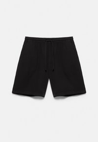 Shorts noirs décontractés avec une taille élastique et un cordon, dotés de poches latérales, posés à plat sur un fond neutre.