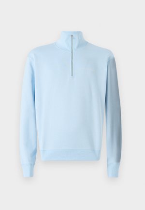 Vaaleansininen huppari, jossa on puolivetoketju, pitkät hihat, ribbaustoiminnot hihansuissa ja helmassa sekä hillitty logomerkintä rinnassa. Pehmeä materiaalitekstuuri.