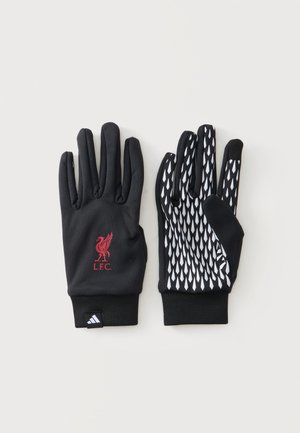 Μαύρα γάντια με το λογότυπο της Liverpool FC σε ένα γάντι και λευκό μοτίβο λαβής στην παλάμη του άλλου, τοποθετημένα επίπεδα σε ανοιχτό φόντο.
