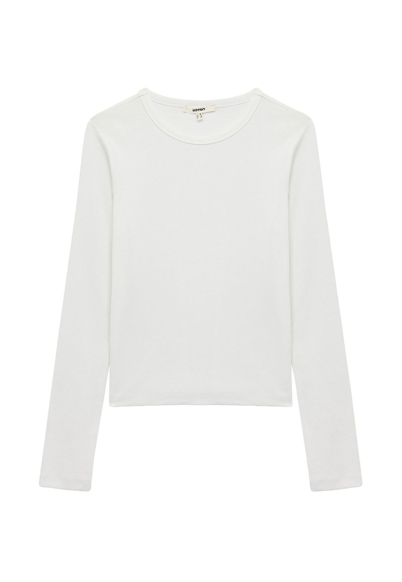 Hvid langærmet skjorte lavet af blød bomuld, med en rund halsudskæring og et let cropped design, med minimale syninger.
