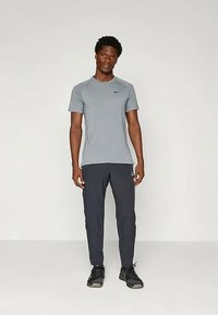 Nike Performance PANT - Tracksuit bottoms - black/white