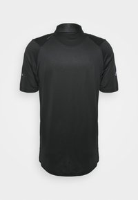 Black short-sleeve polo shirt with a collared neck, made of a smooth, lightweight fabric. Features contrasting shoulder accents.