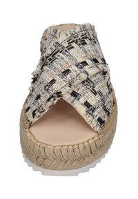 Woven fabric slide sandal with a cross-over design in black, beige, and white. Natural jute sole with white rubber base. Smooth inner lining.