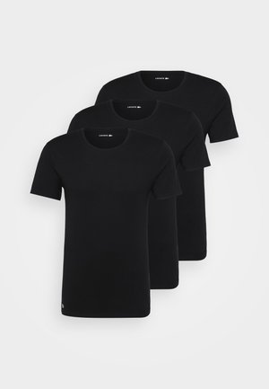 Three black crew neck t-shirts stacked. Made of cotton, featuring short sleeves, a smooth texture, and a small logo on the hem.
