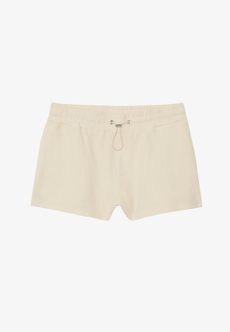 Shorts de bain couleur crème avec un motif texturé en damier, ceinture élastique et cordon de serrage. Longueur mi-cuisse, non doublés.