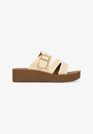 Beige platform sandals featuring a textured faux-crocodile leather upper, two wide straps with a buckle, and a brown rubber sole.
