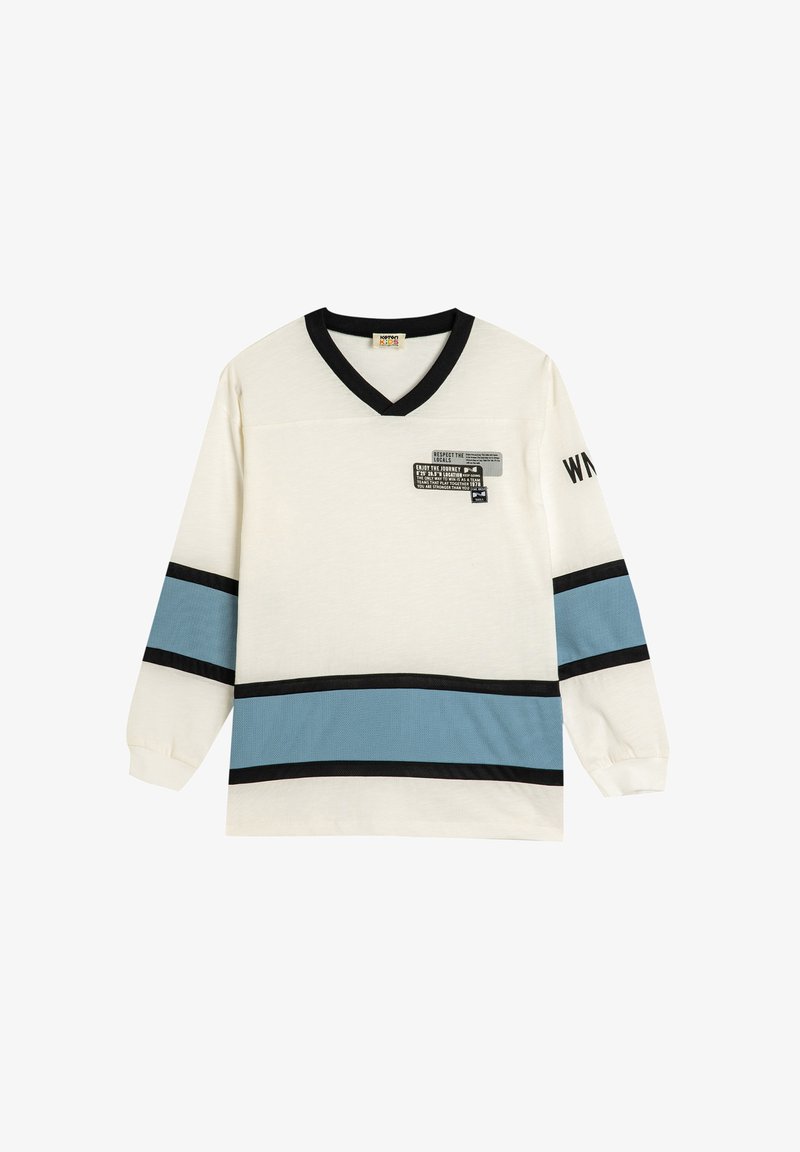 Long-sleeve shirt in cream with black and light blue horizontal stripes. V-neck design features an abstract graphic on the left chest.