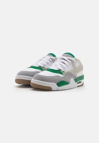 Sneakers with a white leather upper, grey suede accents, green straps, and a gum rubber outsole. Features laces and minimal branding details.