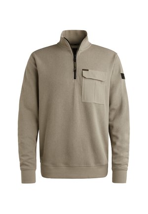 Pull-over beige avec un col zippé, texture côtelée, manches longues et une poche avant. Présente des accents de logo sur la manche.