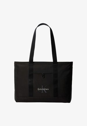 Sac cabas noir Calvin Klein avec deux longues poignées et une poche avant, avec le logo de la marque en blanc et gris.