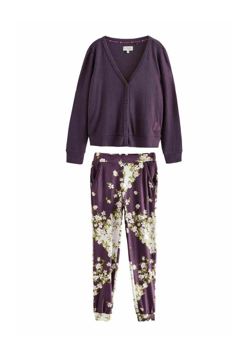Purple ribbed cardigan with V-neck and buttons, paired with floral-patterned pants in shades of purple, white, and green.