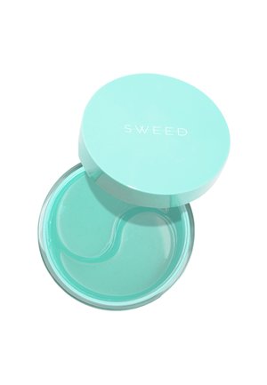 Un récipient rond et transparent avec un couvercle vert menthe. À l'intérieur, un produit en gel de couleur vert menthe similaire, légèrement translucide et à la texture lisse.