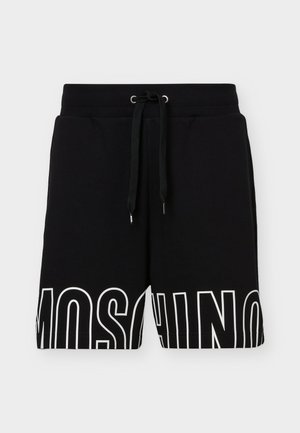 Shorts décontractés noirs avec taille élastique et cordon de serrage, arborant un grand texte blanc "MOSCHINO" sur l'ourlet inférieur.