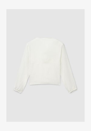 Blouse blanche courte à manches longues avec poignets élastiques, dotée d'un tissu texturé et d'une délicate bordure en dentelle au niveau de l'encolure.