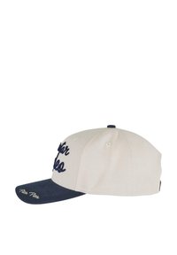 Krém színű korona és sötétkék napellenzővel rendelkező baseball sapka. Hímzett szöveggel a koronán és egy kis logóval a napellenzőn. Fényvászonnal készült.
