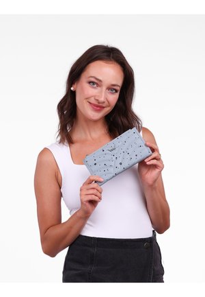 Light blue leather wallet with a wave pattern, embellished with silver metallic dots, zipper closure, and a logo detail on the front.