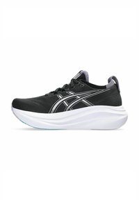 Baskets de sport noires avec une tige texturée, semelle intermédiaire blanche rembourrée et détails argentés sur les côtés. Elles présentent un bout rond et un système de laçage.