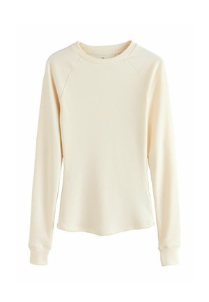 Cremfarbener Langarmoberteil aus geripptem Stoff. Verfügt über einen runden Halsausschnitt und Raglanärmel mit engen Bündchen.