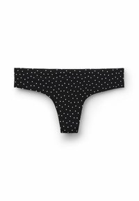 Černý string vyrobený z měkké tkaniny, s bílým puntíkovaným vzorem. Jednoduchý, elastický pas s minimalistickým designem.