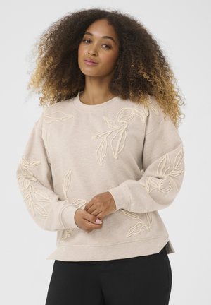 Lichtbeige sweatshirt met 3D-bladborduursel in crème. Relaxed fit met lange mouwen, geribde boorden en een afgeronde zoom.